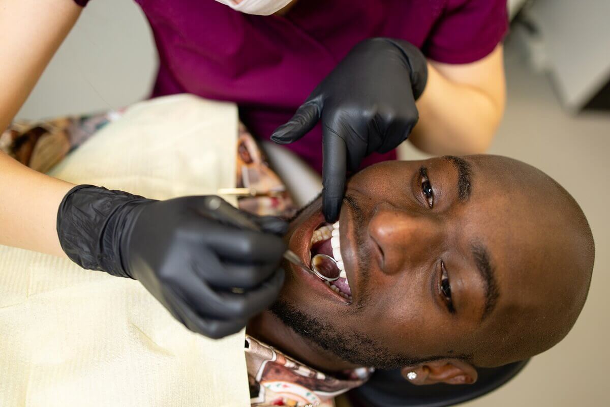 patient getting dental cleaning at dental office