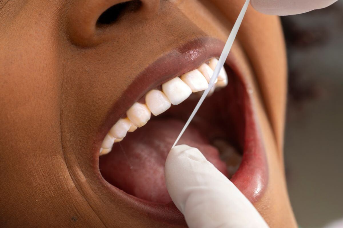 woman flossing to prevent Gum Disease