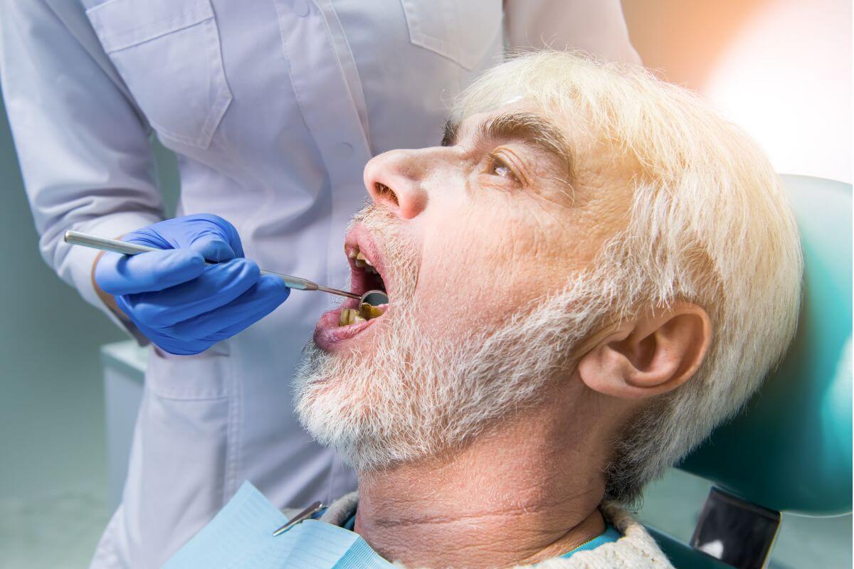 dentist examining adult patient for common dental problems